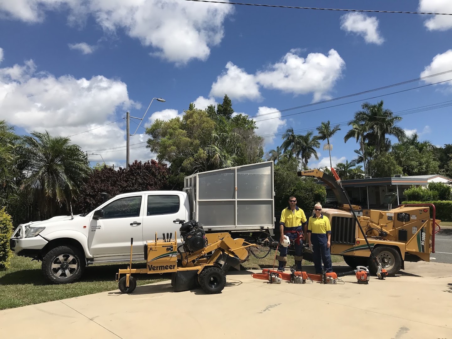 The Urban Arborcare crew standing with their ute, tipper trailer, chipper, stump grinder and saws